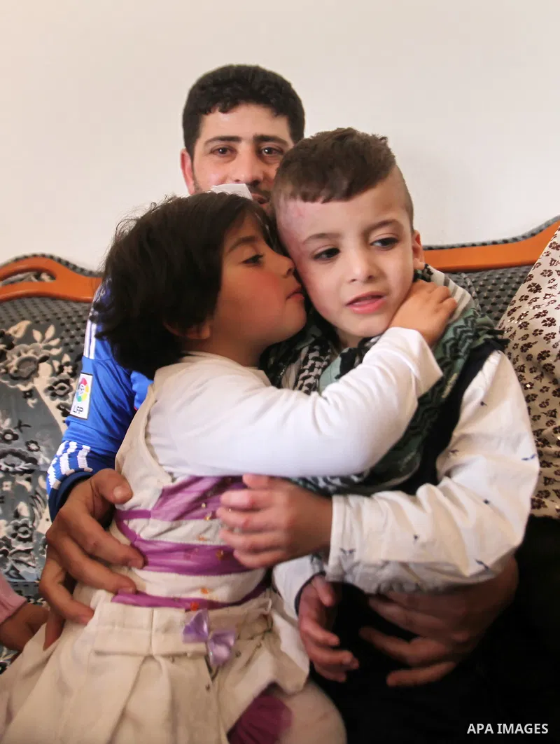 Palestinian boy Ahmed Dawabsha, 5, who suffered severe burns in an arson attack by suspected Jewish attackers on his family home last July and in which his younger brother, Ali, and his parents both died, is welcomed by...