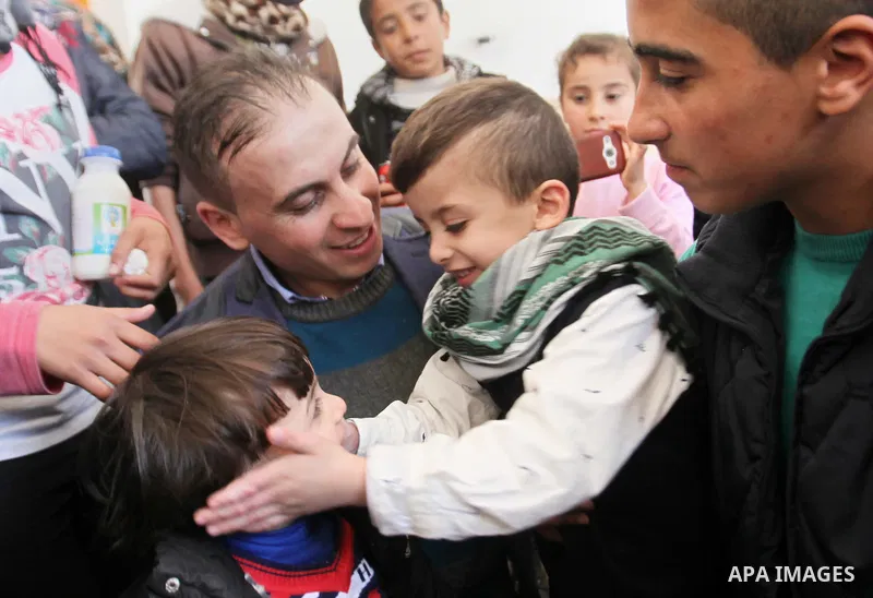 Palestinian boy Ahmed Dawabsha, 5, who suffered severe burns in an arson attack by suspected Jewish attackers on his family home last July and in which his younger brother, Ali, and his parents both died, is welcomed by...