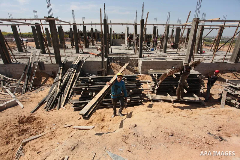 Palestinian construction labourers work on a Turkish funded project to build 320 housing units for families who lost their homes during the 50-day war between Israel and Hamas-led militants in the summer of 2014, east of...