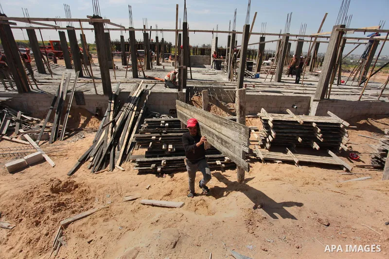 Palestinian construction labourers work on a Turkish funded project to build 320 housing units for families who lost their homes during the 50-day war between Israel and Hamas-led militants in the summer of 2014, east of...