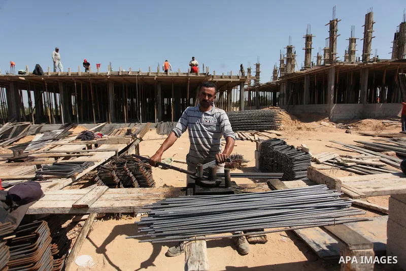 Palestinian construction labourers work on a Turkish funded project to build 320 housing units for families who lost their homes during the 50-day war between Israel and Hamas-led militants in the summer of 2014, east of...