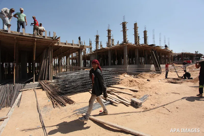 Palestinian construction labourers work on a Turkish funded project to build 320 housing units for families who lost their homes during the 50-day war between Israel and Hamas-led militants in the summer of 2014, east of...