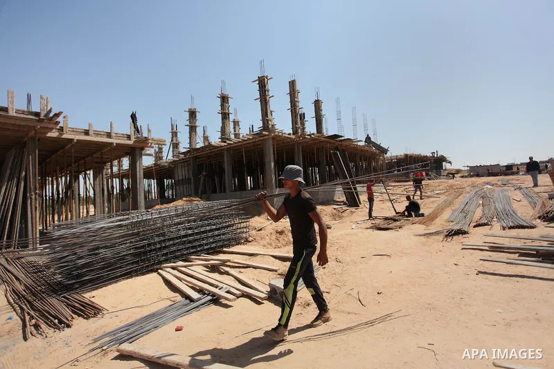 Palestinian construction labourers work on a Turkish funded project to build 320 housing units for families who lost their homes during the 50-day war between Israel and Hamas-led militants in the summer of 2014, east of...