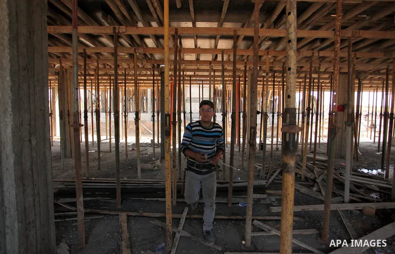 Palestinian construction labourers work on a Turkish funded project to build 320 housing units for families who lost their homes during the 50-day war between Israel and Hamas-led militants in the summer of 2014, east of...