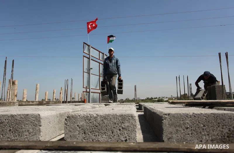 Palestinian construction labourers work on a Turkish funded project to build 320 housing units for families who lost their homes during the 50-day war between Israel and Hamas-led militants in the summer of 2014, east of...