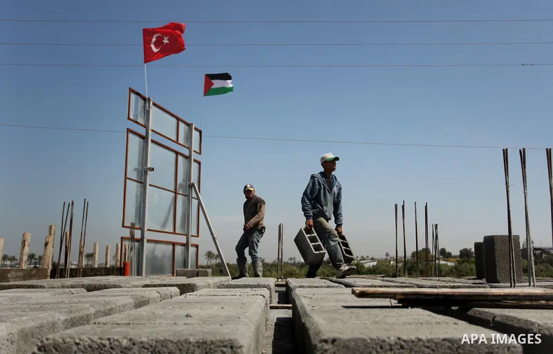 Palestinian construction labourers work on a Turkish funded project to build 320 housing units for families who lost their homes during the 50-day war between Israel and Hamas-led militants in the summer of 2014, east of...