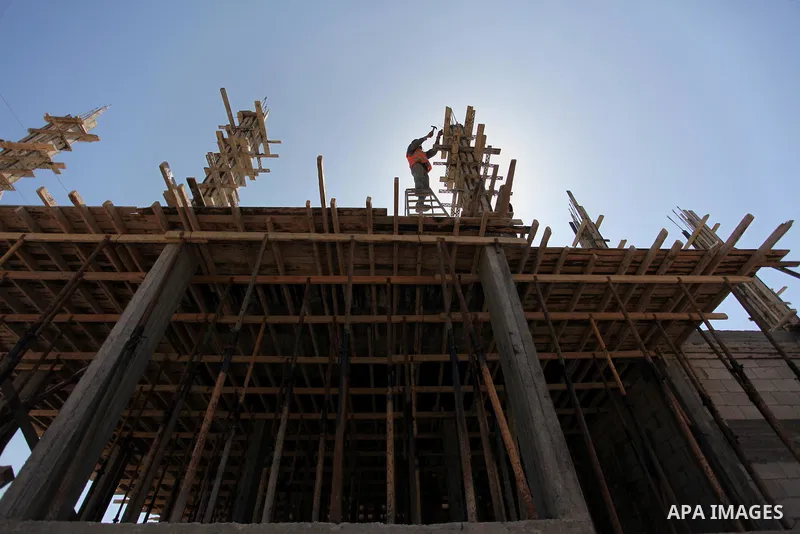 Palestinian construction labourers work on a Turkish funded project to build 320 housing units for families who lost their homes during the 50-day war between Israel and Hamas-led militants in the summer of 2014, east of...