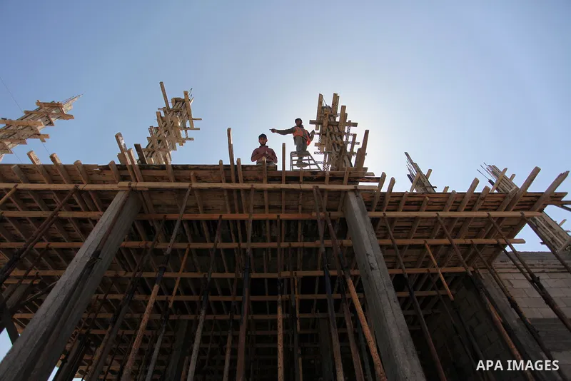 Palestinian construction labourers work on a Turkish funded project to build 320 housing units for families who lost their homes during the 50-day war between Israel and Hamas-led militants in the summer of 2014, east of...