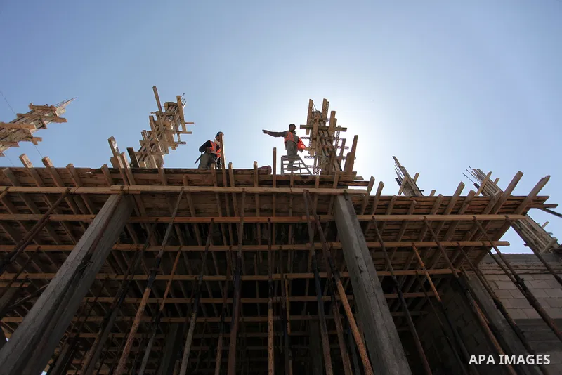 Palestinian construction labourers work on a Turkish funded project to build 320 housing units for families who lost their homes during the 50-day war between Israel and Hamas-led militants in the summer of 2014, east of...