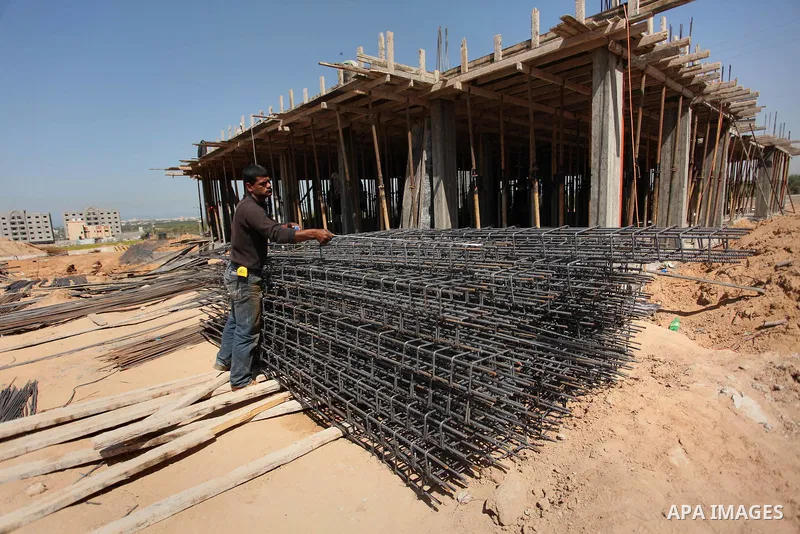 Palestinian construction labourers work on a Turkish funded project to build 320 housing units for families who lost their homes during the 50-day war between Israel and Hamas-led militants in the summer of 2014, east of...