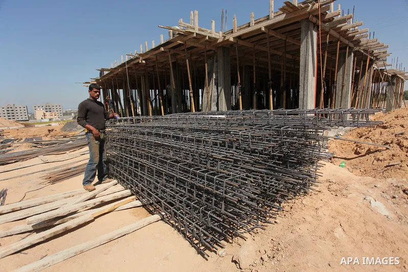 Palestinian construction labourers work on a Turkish funded project to build 320 housing units for families who lost their homes during the 50-day war between Israel and Hamas-led militants in the summer of 2014, east of...