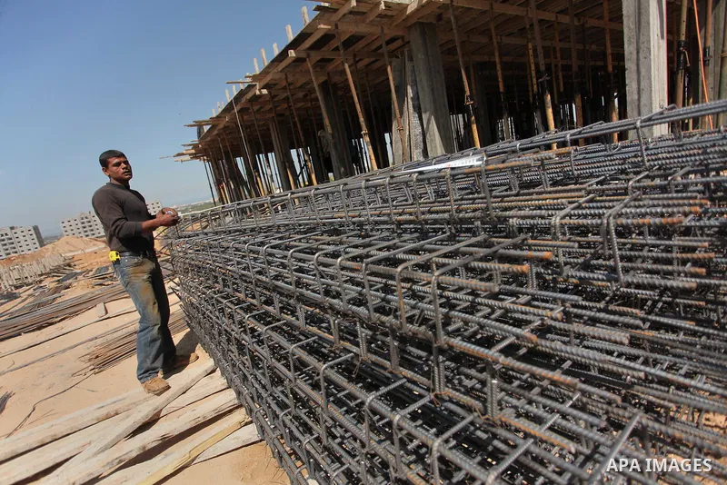 Palestinian construction labourers work on a Turkish funded project to build 320 housing units for families who lost their homes during the 50-day war between Israel and Hamas-led militants in the summer of 2014, east of...