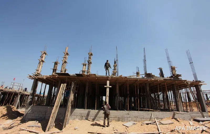 Palestinian construction labourers work on a Turkish funded project to build 320 housing units for families who lost their homes during the 50-day war between Israel and Hamas-led militants in the summer of 2014, east of...