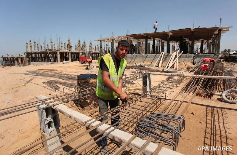 Palestinian construction labourers work on a Turkish funded project to build 320 housing units for families who lost their homes during the 50-day war between Israel and Hamas-led militants in the summer of 2014, east of...