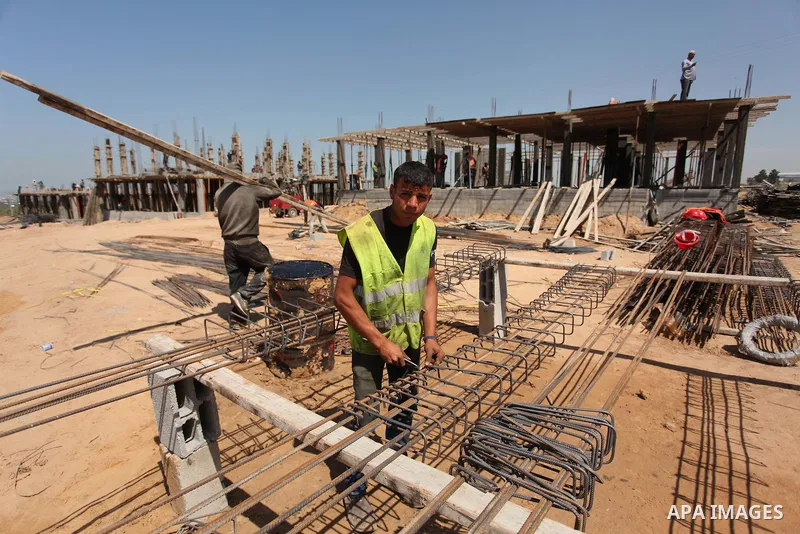 Palestinian construction labourers work on a Turkish funded project to build 320 housing units for families who lost their homes during the 50-day war between Israel and Hamas-led militants in the summer of 2014, east of...