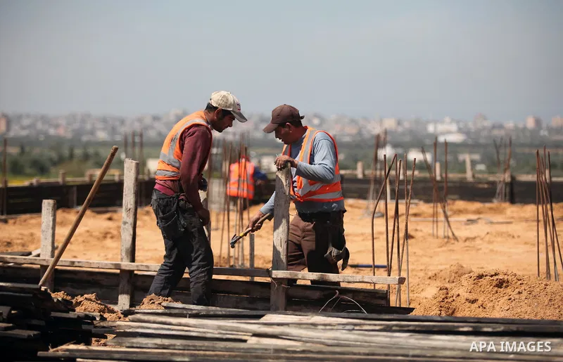 Palestinian construction labourers work on a Turkish funded project to build 320 housing units for families who lost their homes during the 50-day war between Israel and Hamas-led militants in the summer of 2014, east of...