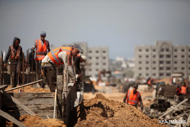 Palestinian construction labourers work on a Turkish funded project to build 320 housing units for families who lost their homes during the 50-day war between Israel and Hamas-led militants in the summer of 2014, east of...