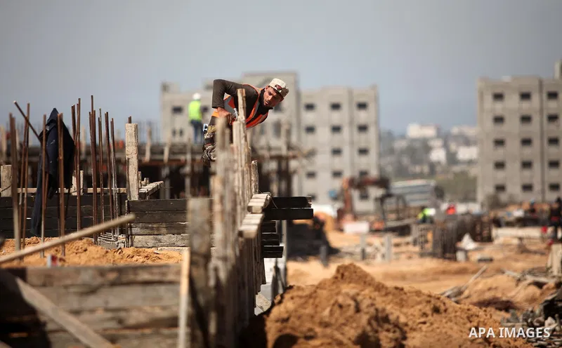 Palestinian construction labourers work on a Turkish funded project to build 320 housing units for families who lost their homes during the 50-day war between Israel and Hamas-led militants in the summer of 2014, east of...
