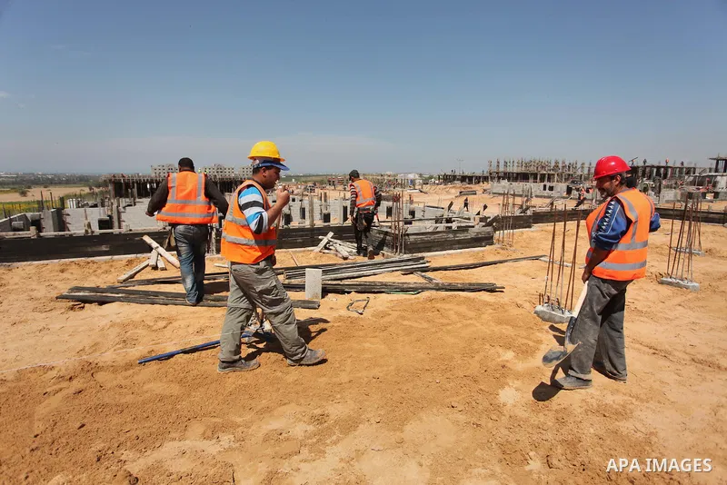 Palestinian construction labourers work on a Turkish funded project to build 320 housing units for families who lost their homes during the 50-day war between Israel and Hamas-led militants in the summer of 2014, east of...