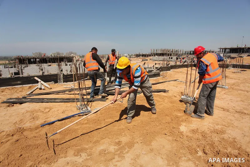 Palestinian construction labourers work on a Turkish funded project to build 320 housing units for families who lost their homes during the 50-day war between Israel and Hamas-led militants in the summer of 2014, east of...