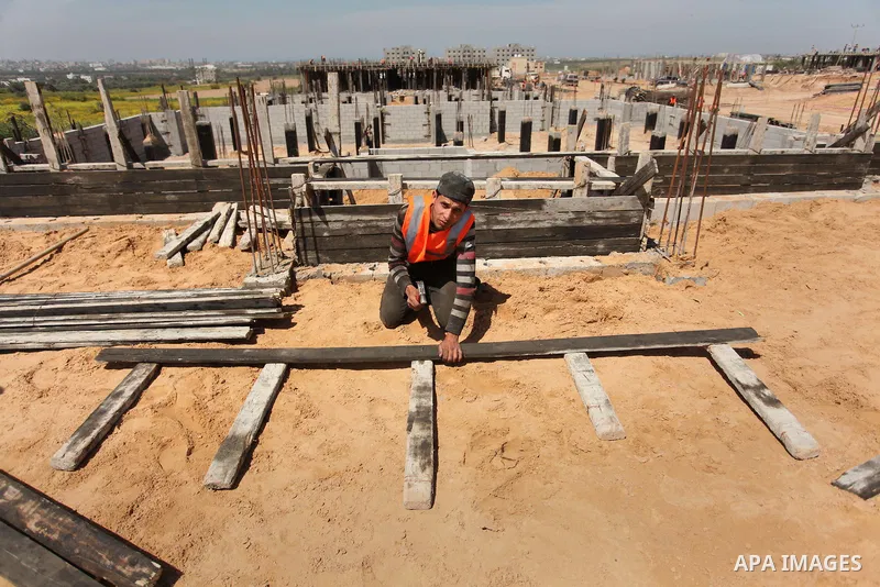 Palestinian construction labourers work on a Turkish funded project to build 320 housing units for families who lost their homes during the 50-day war between Israel and Hamas-led militants in the summer of 2014, east of...