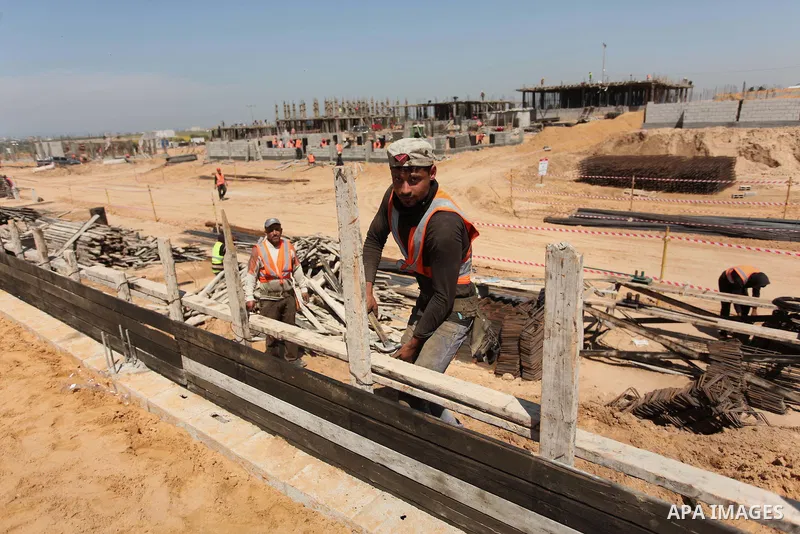 Palestinian construction labourers work on a Turkish funded project to build 320 housing units for families who lost their homes during the 50-day war between Israel and Hamas-led militants in the summer of 2014, east of...