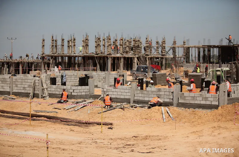 Palestinian construction labourers work on a Turkish funded project to build 320 housing units for families who lost their homes during the 50-day war between Israel and Hamas-led militants in the summer of 2014, east of...
