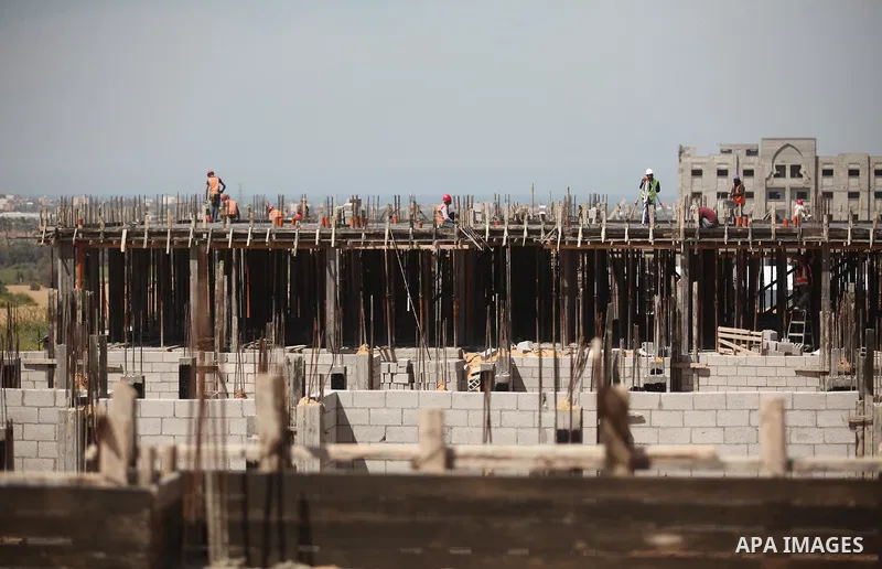 Palestinian construction labourers work on a Turkish funded project to build 320 housing units for families who lost their homes during the 50-day war between Israel and Hamas-led militants in the summer of 2014, east of...