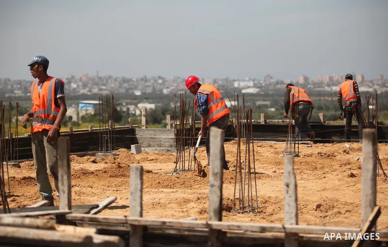 Palestinian construction labourers work on a Turkish funded project to build 320 housing units for families who lost their homes during the 50-day war between Israel and Hamas-led militants in the summer of 2014, east of...