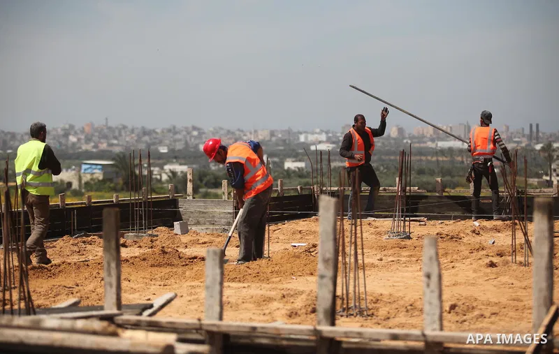 Palestinian construction labourers work on a Turkish funded project to build 320 housing units for families who lost their homes during the 50-day war between Israel and Hamas-led militants in the summer of 2014, east of...