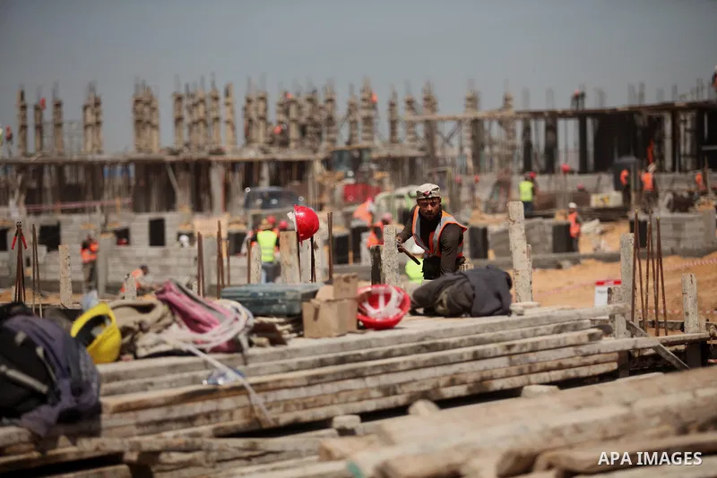 Palestinian construction labourers work on a Turkish funded project to build 320 housing units for families who lost their homes during the 50-day war between Israel and Hamas-led militants in the summer of 2014, east of...