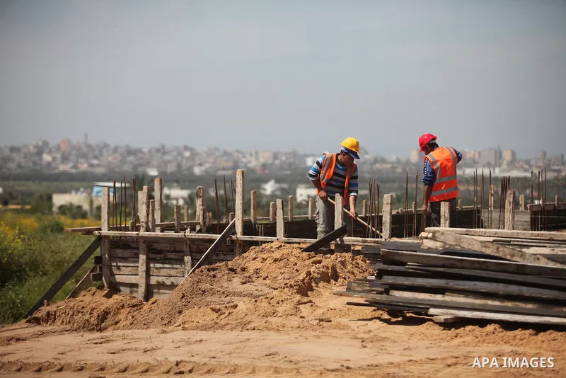Palestinian construction labourers work on a Turkish funded project to build 320 housing units for families who lost their homes during the 50-day war between Israel and Hamas-led militants in the summer of 2014, east of...