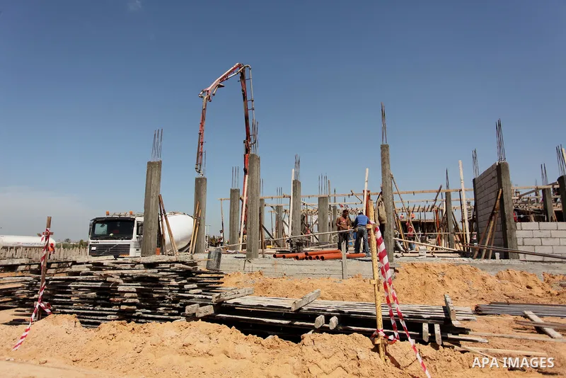 Palestinian construction labourers work on a Turkish funded project to build 320 housing units for families who lost their homes during the 50-day war between Israel and Hamas-led militants in the summer of 2014, east of...
