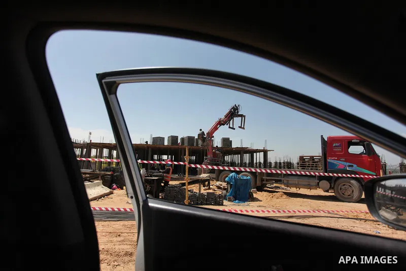 Palestinian construction labourers work on a Turkish funded project to build 320 housing units for families who lost their homes during the 50-day war between Israel and Hamas-led militants in the summer of 2014, east of...