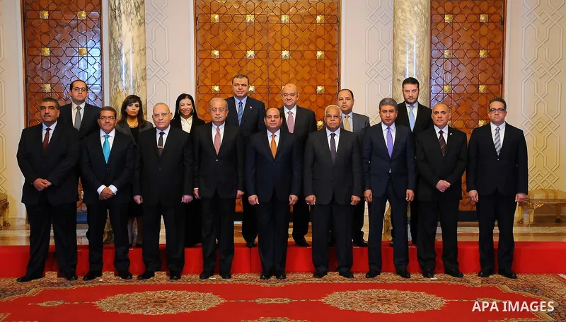 Egyptian President Abdel Fattah al-Sisi poses for a picture with members of the newly appointed cabinet following a meeting in the capital Cairo on March 23, 2016. Sisi swore in 10 new ministers in a cabinet reshuffle, a...