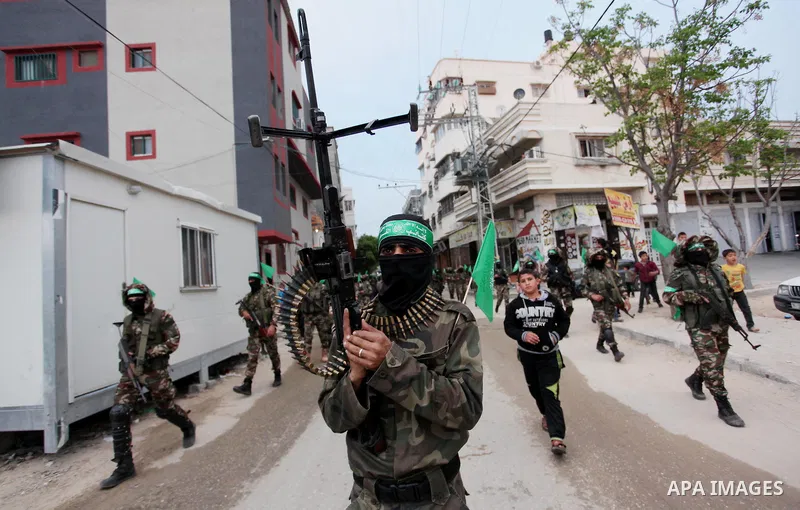 Members of the Ezzedine al-Qassam Brigades, the military wing of the Palestinian Islamist movement Hamas take part during a rally to mark the 12th anniversary of the death of assassinated Hamas spiritual leader Sheikh Ah...