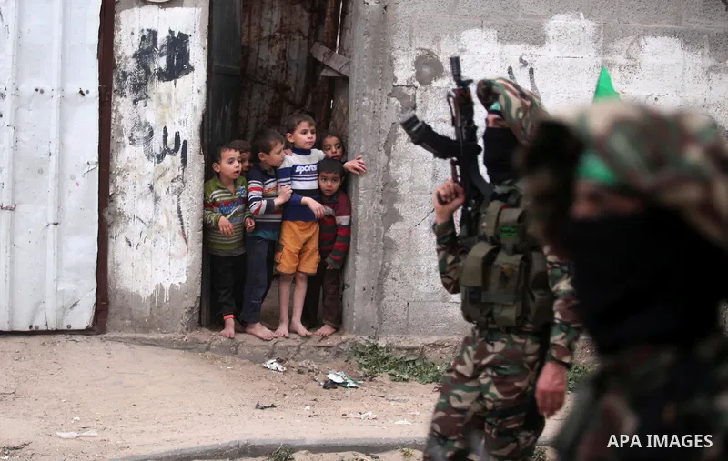 Members of the Ezzedine al-Qassam Brigades, the military wing of the Palestinian Islamist movement Hamas take part during a rally to mark the 12th anniversary of the death of assassinated Hamas spiritual leader Sheikh Ah...