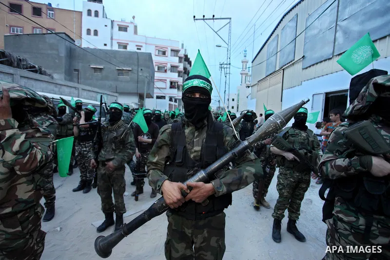Members of the Ezzedine al-Qassam Brigades, the military wing of the Palestinian Islamist movement Hamas take part during a rally to mark the 12th anniversary of the death of assassinated Hamas spiritual leader Sheikh Ah...