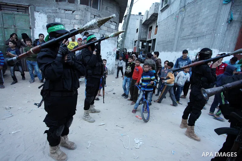 Members of the Ezzedine al-Qassam Brigades, the military wing of the Palestinian Islamist movement Hamas take part during a rally to mark the 12th anniversary of the death of assassinated Hamas spiritual leader Sheikh Ah...