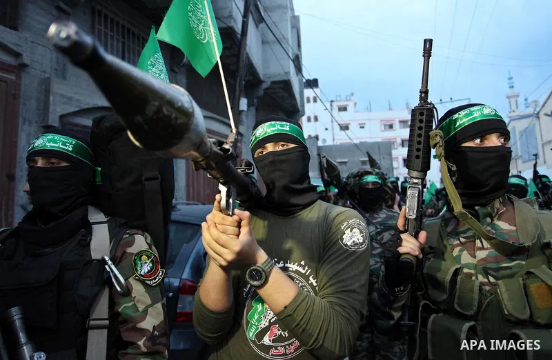 Members of the Ezzedine al-Qassam Brigades, the military wing of the Palestinian Islamist movement Hamas take part during a rally to mark the 12th anniversary of the death of assassinated Hamas spiritual leader Sheikh Ah...