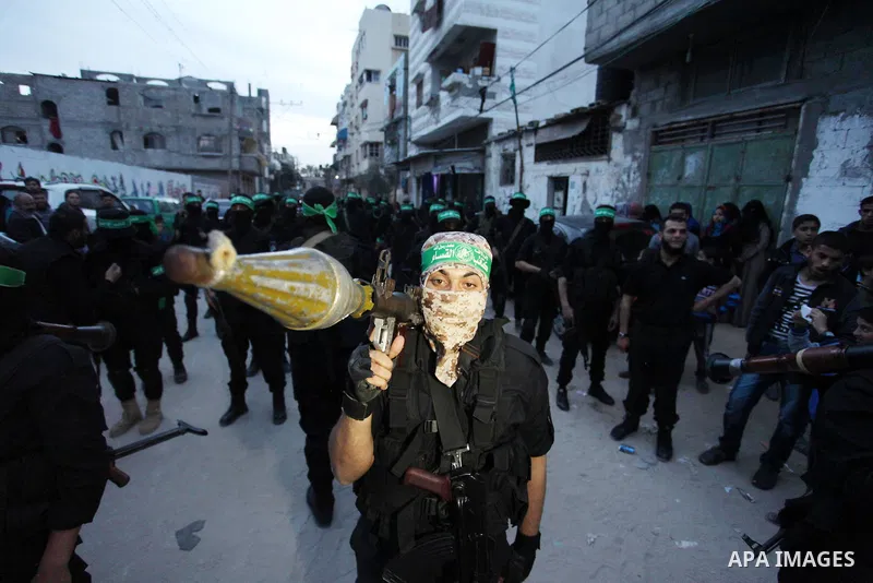 Members of the Ezzedine al-Qassam Brigades, the military wing of the Palestinian Islamist movement Hamas take part during a rally to mark the 12th anniversary of the death of assassinated Hamas spiritual leader Sheikh Ah...