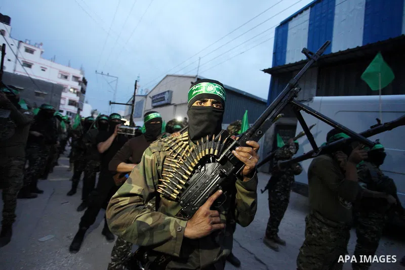 Members of the Ezzedine al-Qassam Brigades, the military wing of the Palestinian Islamist movement Hamas take part during a rally to mark the 12th anniversary of the death of assassinated Hamas spiritual leader Sheikh Ah...