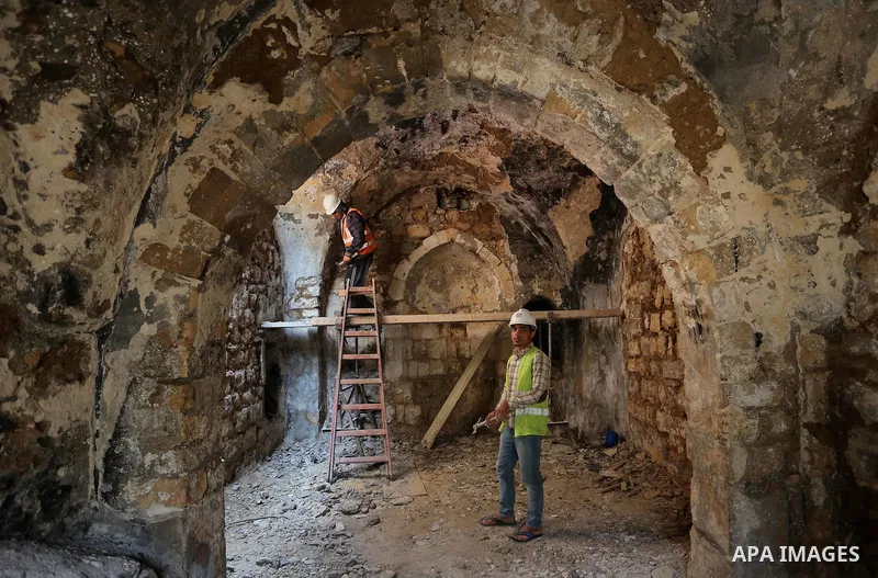 A Palestinian worker renovates the archaeological Maqam Al-Khader, in Deir al-Balah, central Gaza on March 24, 2016. Maqam Al-Kader is one of the monuments of the city of Deir al-Balah, the Ministry of Tourism and Antiqu...