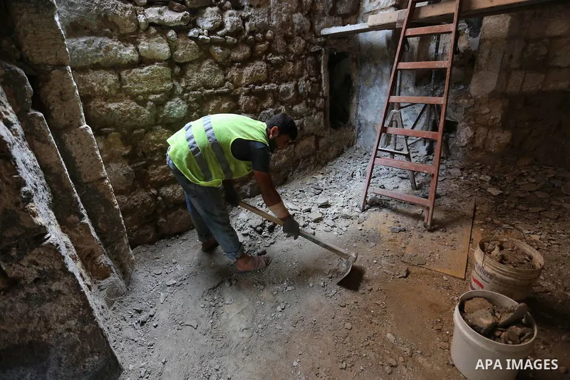 A Palestinian worker renovates the archaeological Maqam Al-Khader, in Deir al-Balah, central Gaza on March 24, 2016. Maqam Al-Kader is one of the monuments of the city of Deir al-Balah, the Ministry of Tourism and Antiqu...