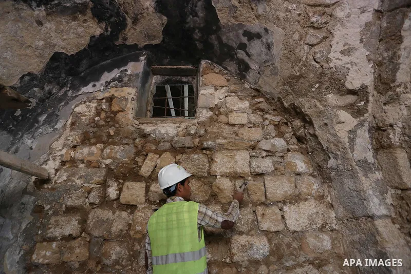 A Palestinian worker renovates the archaeological Maqam Al-Khader, in Deir al-Balah, central Gaza on March 24, 2016. Maqam Al-Kader is one of the monuments of the city of Deir al-Balah, the Ministry of Tourism and Antiqu...