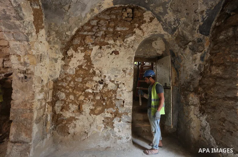 A Palestinian worker renovates the archaeological Maqam Al-Khader, in Deir al-Balah, central Gaza on March 24, 2016. Maqam Al-Kader is one of the monuments of the city of Deir al-Balah, the Ministry of Tourism and Antiqu...
