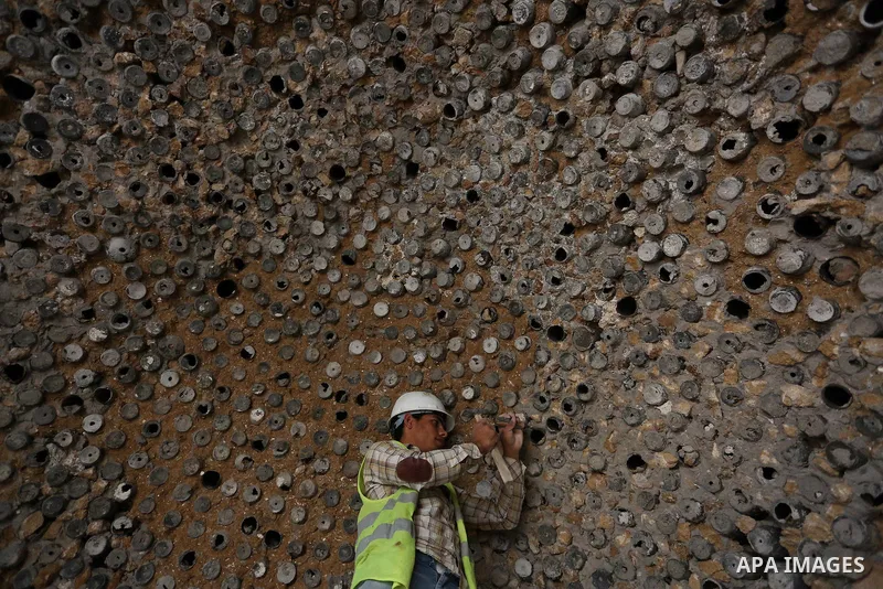 A Palestinian worker renovates the archaeological Maqam Al-Khader, in Deir al-Balah, central Gaza on March 24, 2016. Maqam Al-Kader is one of the monuments of the city of Deir al-Balah, the Ministry of Tourism and Antiqu...