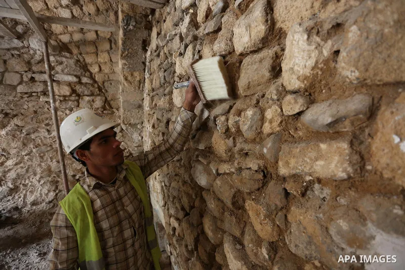 A Palestinian worker renovates the archaeological Maqam Al-Khader, in Deir al-Balah, central Gaza on March 24, 2016. Maqam Al-Kader is one of the monuments of the city of Deir al-Balah, the Ministry of Tourism and Antiqu...