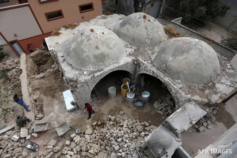 Palestinian workers renovate the archaeological Maqam Al-Khader, in Deir al-Balah, central Gaza on March 24, 2016. Maqam Al-Kader is one of the monuments of the city of Deir al-Balah, the Ministry of Tourism and Antiquit...