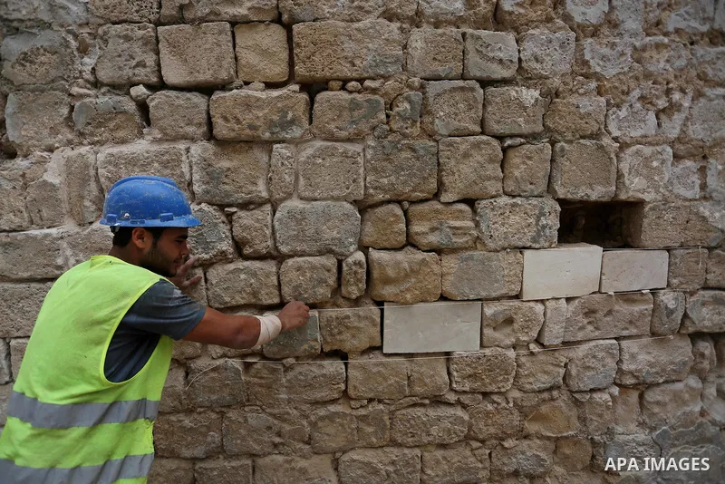 A Palestinian worker renovates the archaeological Maqam Al-Khader, in Deir al-Balah, central Gaza on March 24, 2016. Maqam Al-Kader is one of the monuments of the city of Deir al-Balah, the Ministry of Tourism and Antiqu...